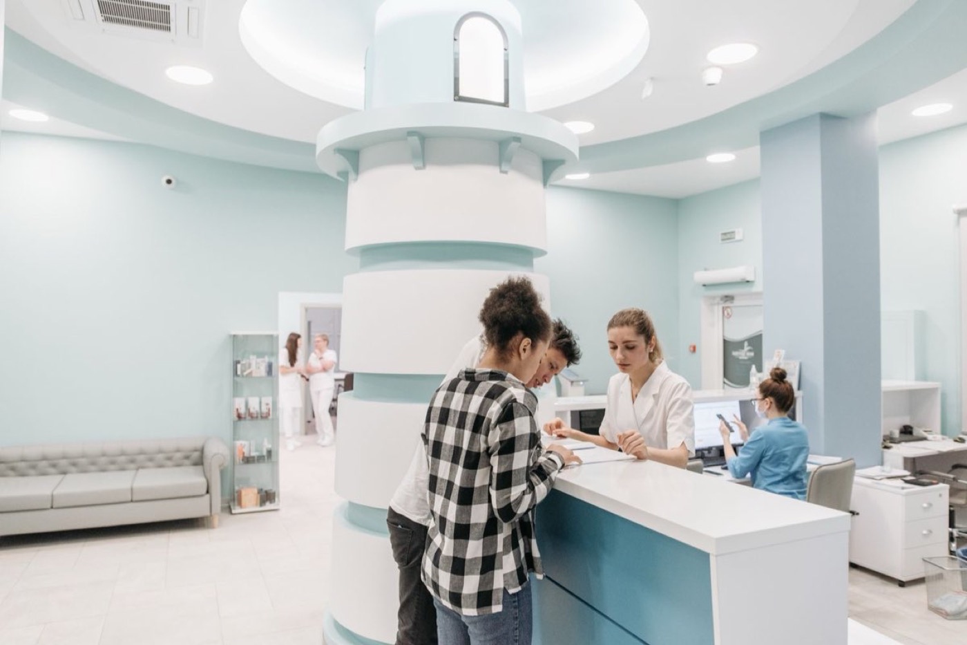 Patients at a dental clinic front desk